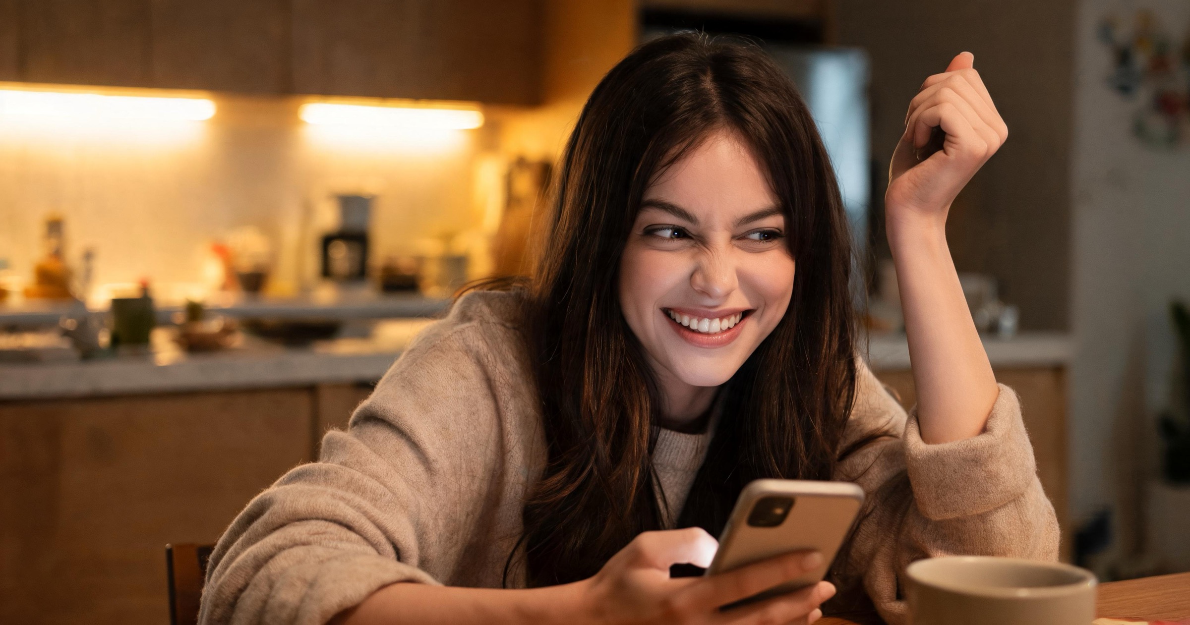 Woman at a kitchen table giving a playful eye-roll at a teasing message from her AI companion
